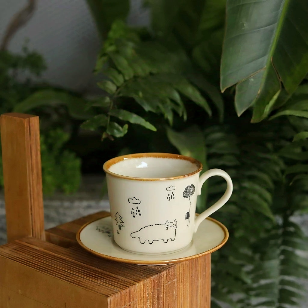 Adorable kawaii ceramic cup with hand-painted rainy day cat design. This Scandinavian folk art style mug is microwave-safe and perfect for warm drinks in soft Nordic or colorful interiors.