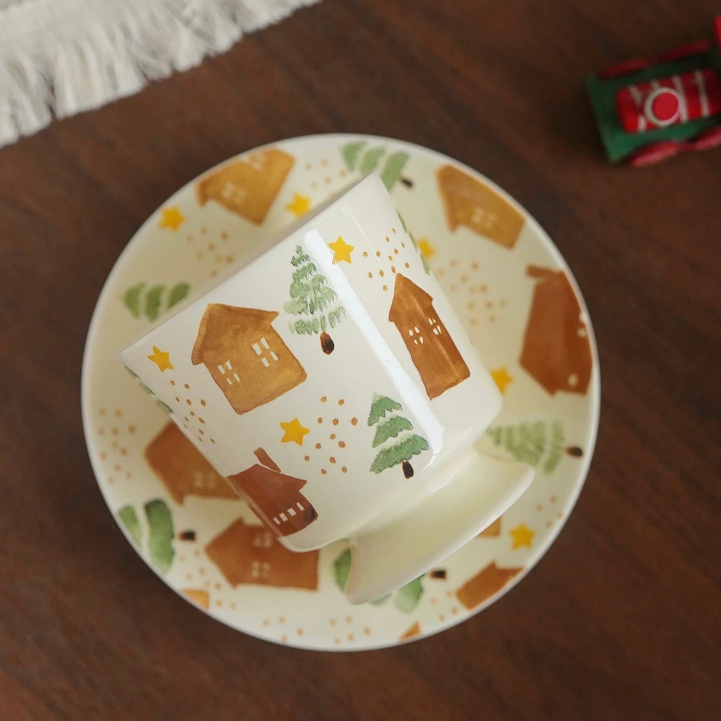 Cute footed cup with illustrated houses and pine trees, ideal for cozy Nordic-inspired homes. Durable and high-quality ceramic.