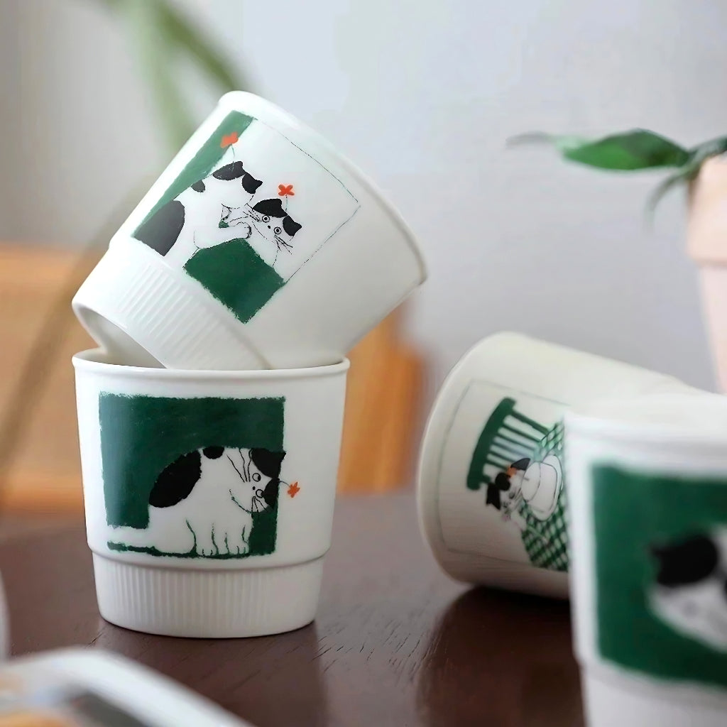 A collection of whimsical handmade ceramic mugs, each featuring a different playful kitten scene. Microwave-safe and made from durable glazed ceramic with 280ml capacity—ideal for gifting or daily use.
