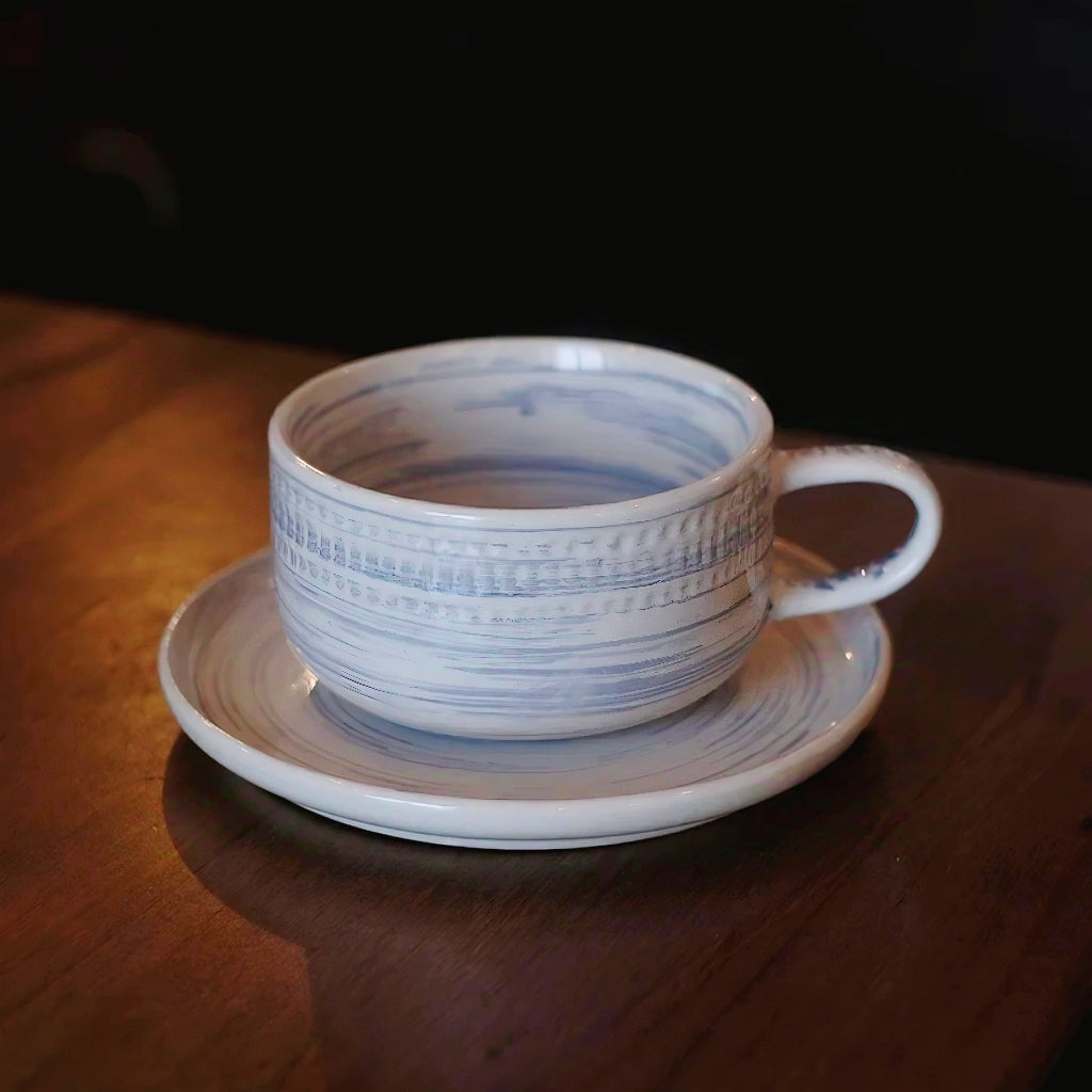 Elegant drinkware set featuring a handmade stoneware cup and matching neutral saucer. Durable and microwave-safe stoneware