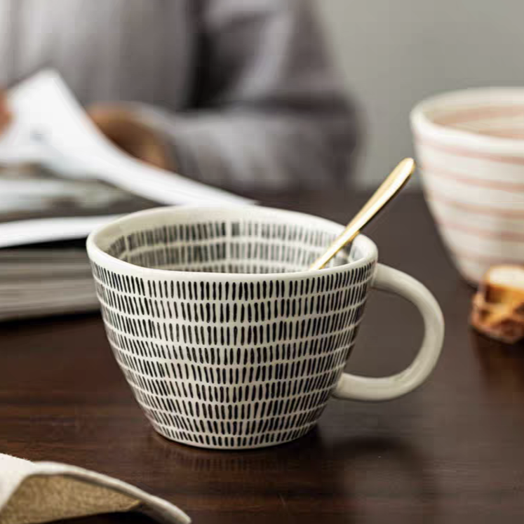 Neutral ceramic coffee mug with a simple yet elegant dot design. Perfect for iced or hot beverages