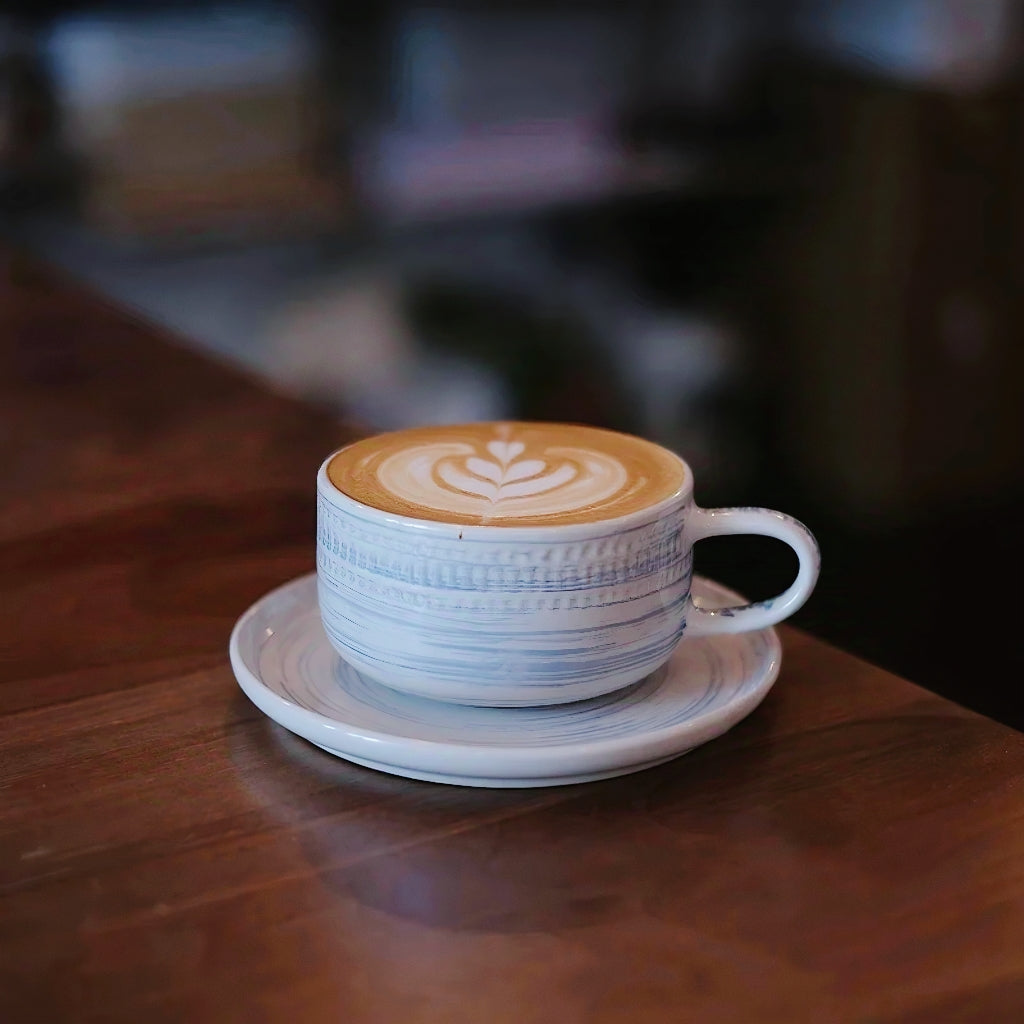 Artisan-style ceramic mug with textured finish and soft hues, ideal for cozy home decor. Beautiful and functional drinkware gift.