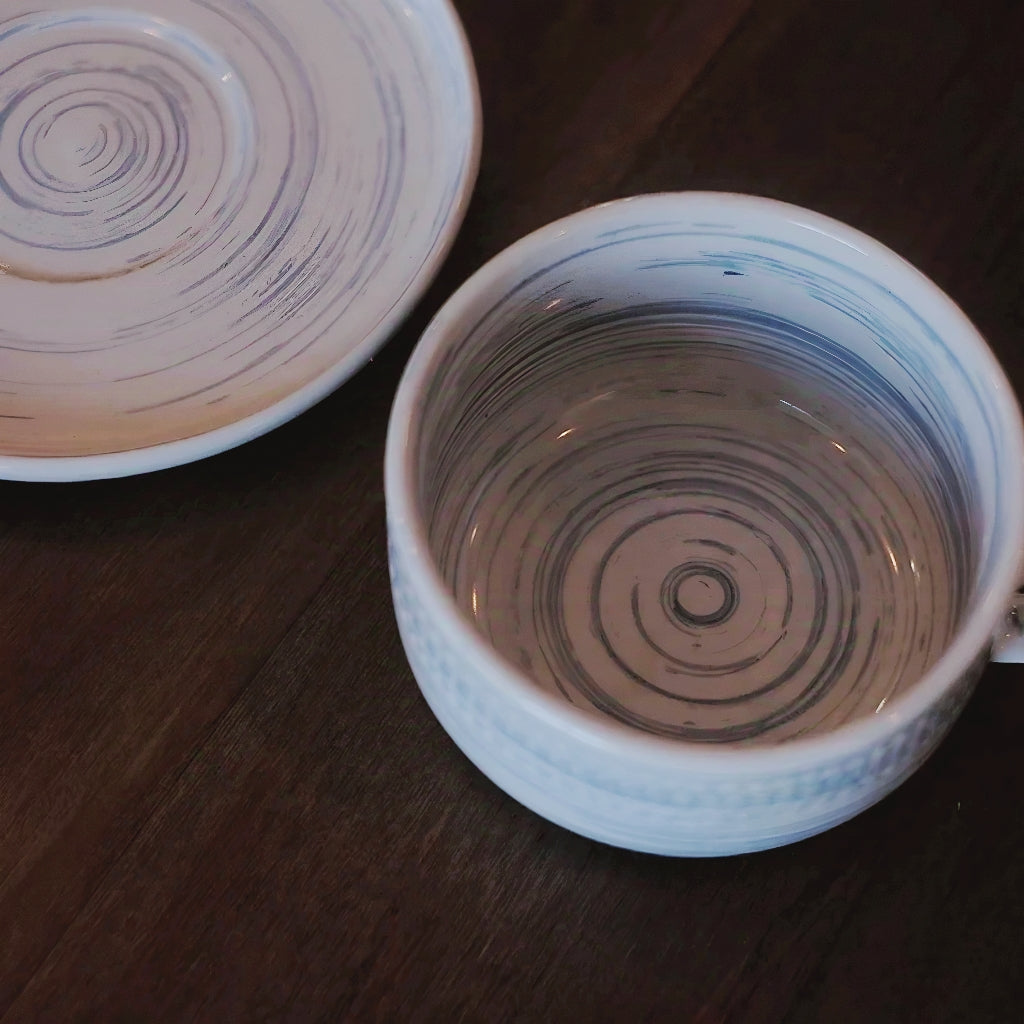Decorative coffee cup with delicate horizontal lines, a unique gift for tea lovers.