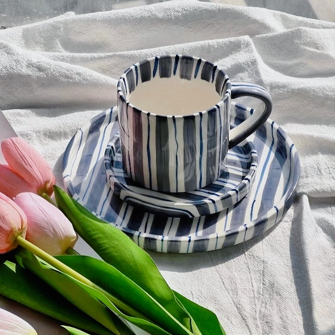 Chic striped ceramic cup and plate set with a modern cerulean blue color scheme, craft from premium ceramic, ideal for creating an elegant and stylish table setting.