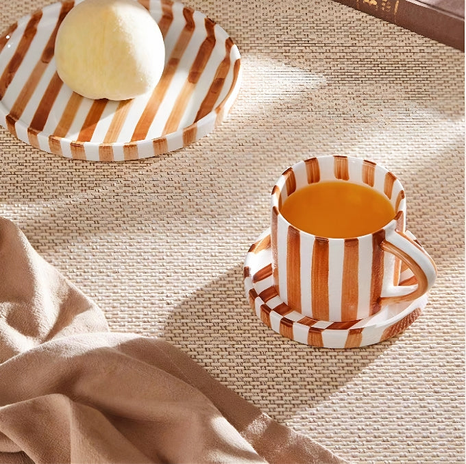 Premium ceramic cup and plate set in burnt orange, featuring hand-painted stripes and Nordic-inspired minimalist design for elegant dining.