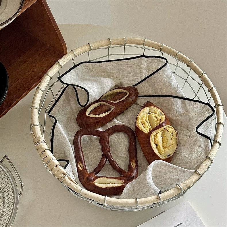 Scandinavian minimalism basket holding an assortment of breads, perfect for a warm and natural-inspired home decor.