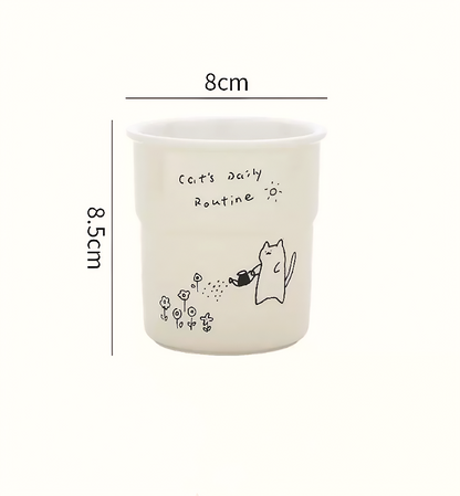 Handcrafted pottery cup with sweet kitten watering plants illustration on a cream glaze background. Ideal for aesthetic interiors, a unique coffee mug for tea lovers and gardeners.