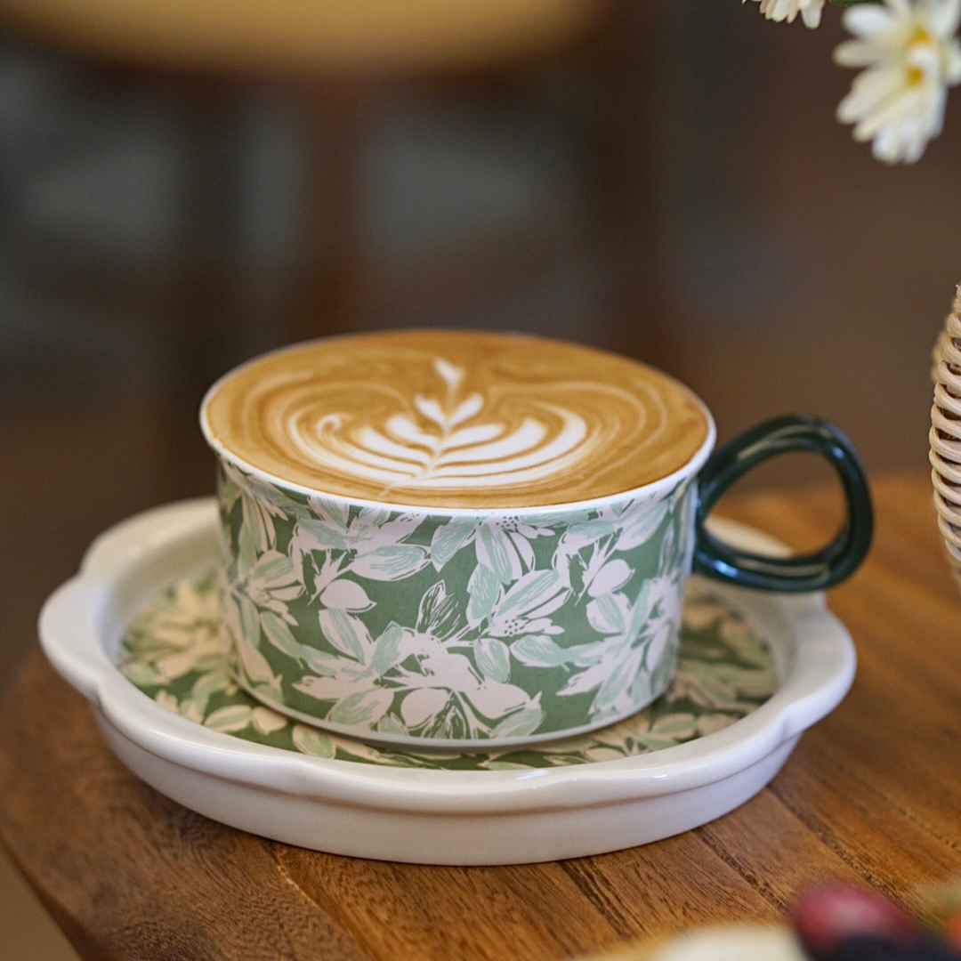 Scandinavian-style ceramic cup featuring hand-painted lilies and minimalist springtime garden theme. Ideal for iced or hot drink.