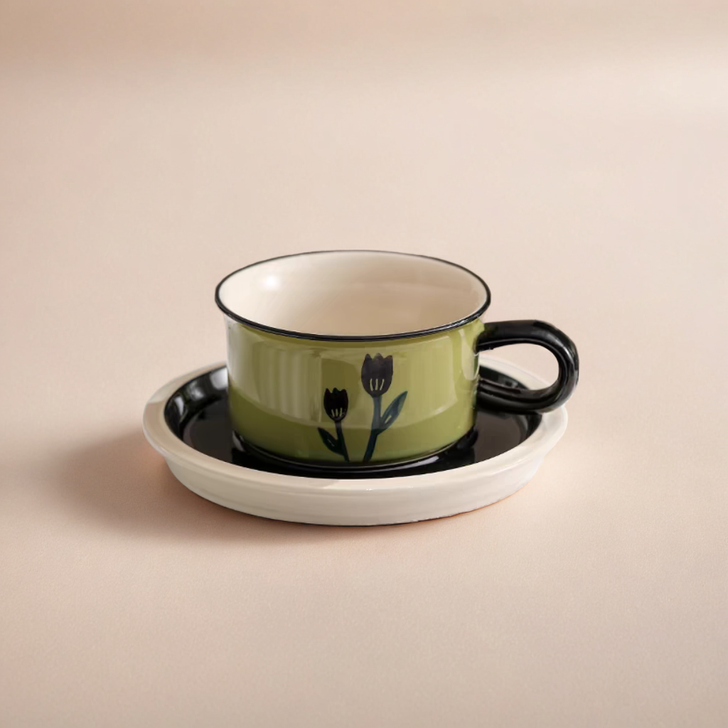 A ceramic coffee cup and saucer with a tulip pattern, ergonomic handle, and modern vintage design.