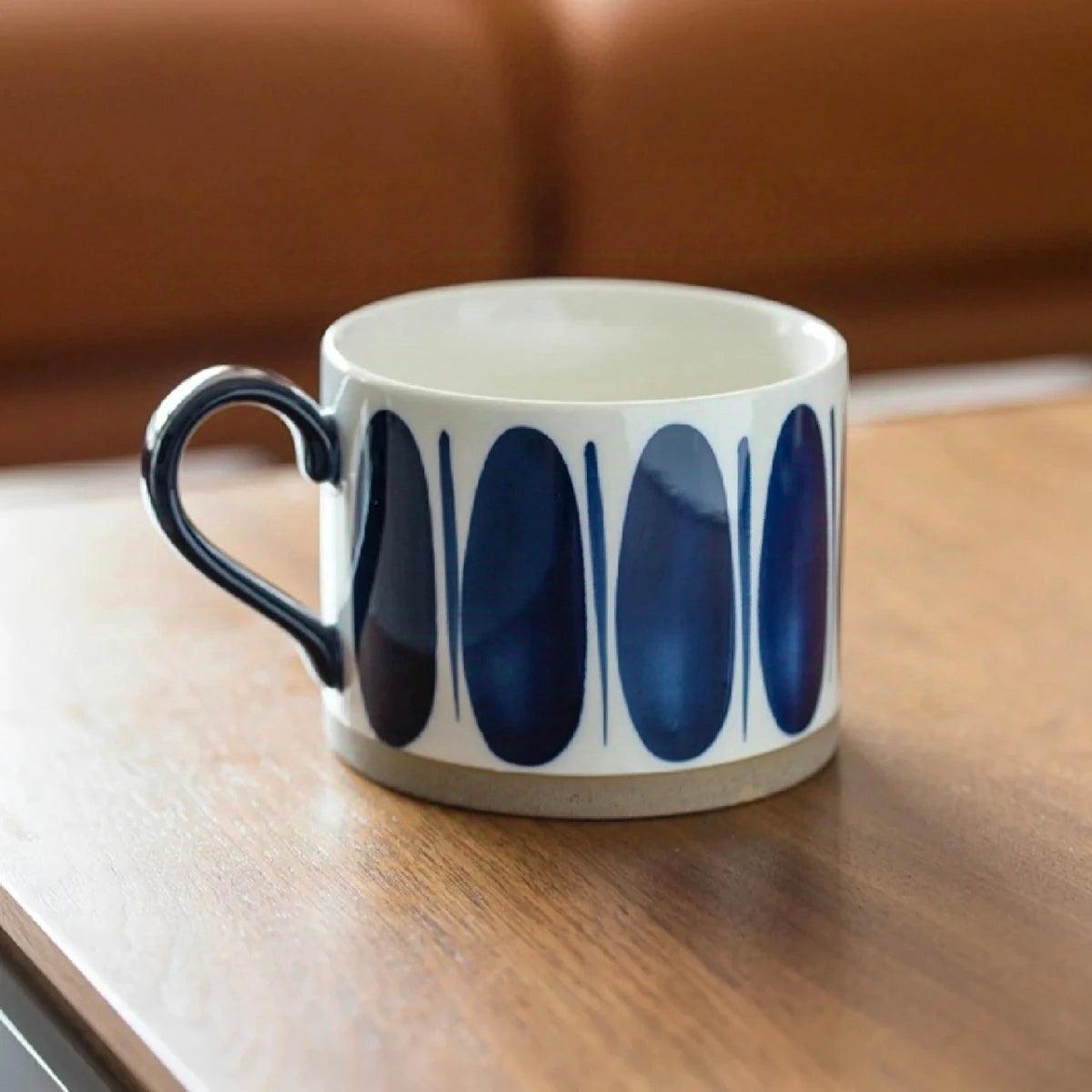 Hand-painted ceramic mug featuring a Nordic blue oval pattern, ideal for coffee and tea lovers.