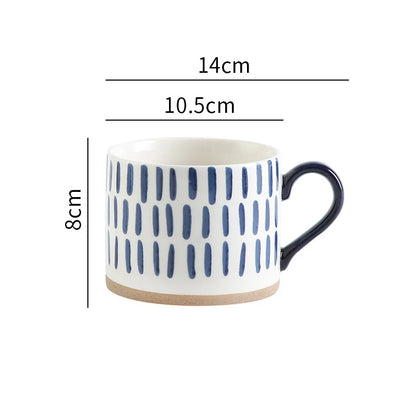 Elegant ceramic mug with hand-painted blue vertical lines, perfect for minimalist homes.