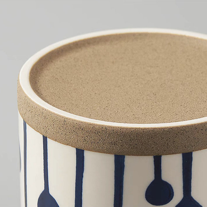 Showcase of the bottom of the cream-white and ceramic cups with unique blue patterns, ideal for coffee, tea, and milk in stylish, minimalist settings.