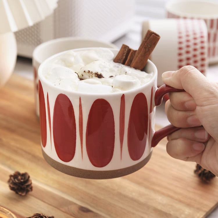 Sophisticated red and cream ceramic mug, a perfect addition to Scandinavian-themed home decor.