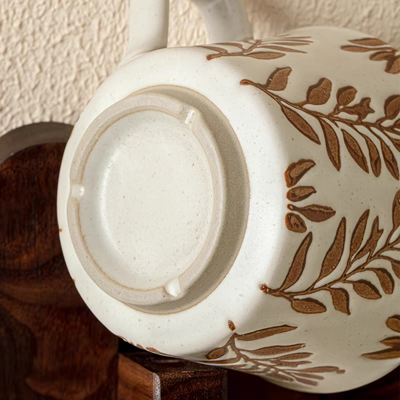 Detailed view of the coarse pottery texture on a ceramic mug, emphasizing its handcrafted design and neutral color.