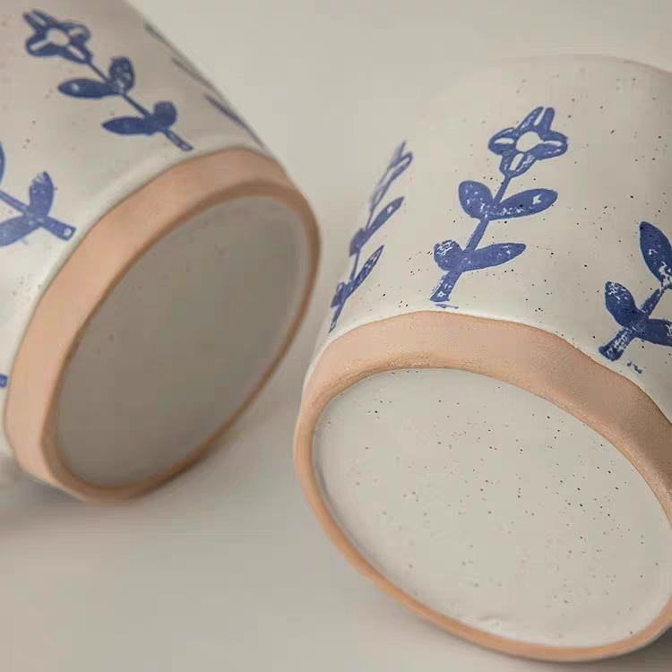 Detailed view of the bottom of the premium ceramic mug, emphasizing its handcrafted design and neutral color.