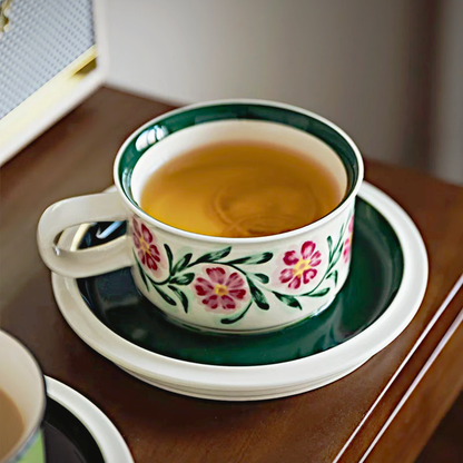 A vintage-style ceramic coffee cup featuring a detailed floral pattern, ideal for home or office use.