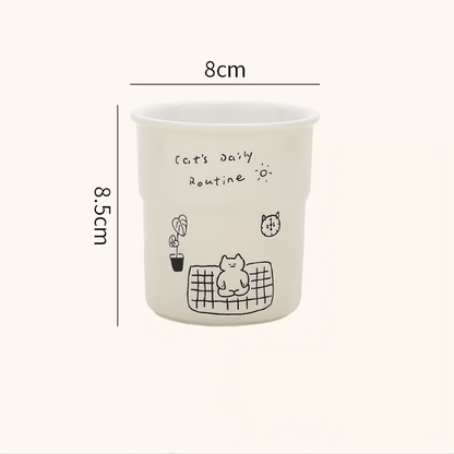 Whimsical handmade pottery mug featuring a meditating kitten illustration, perfect for cozy Scandinavian-style homes. Microwave-safe, dishwasher-safe, and ideal for tea, coffee, or gifting to cat lovers.