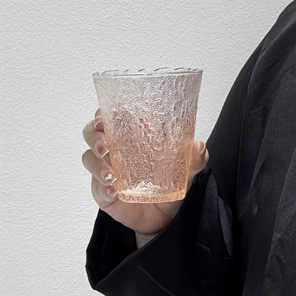 Orange gradient glass cup with glacier patterns. Durable, high-quality design for cocktails, tea, and juice in contemporary settings.