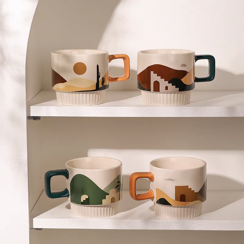 Sturdy ceramic cup with a vibrant desert landscape design, offering a comfortable handle for coffee or tea lovers.