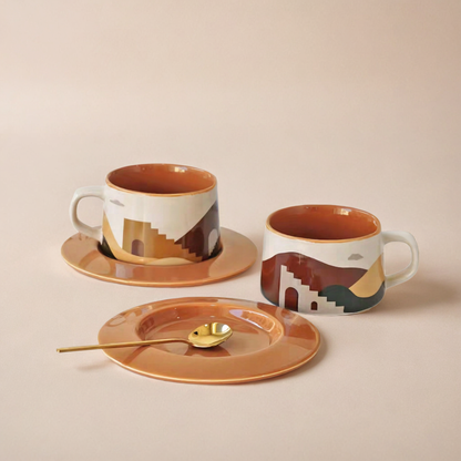  Two ceramic coffee cup and plate sets with desert and oasis designs, showcasing premium craftsmanship, modern aesthetic, and 250 ml capacity for coffee or tea.