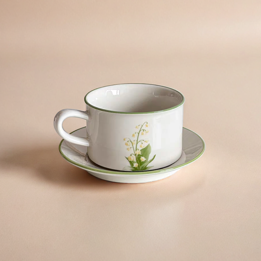 Lily of the Valley-themed ceramic mug with a matching plate, perfect for minimalistic interiors.