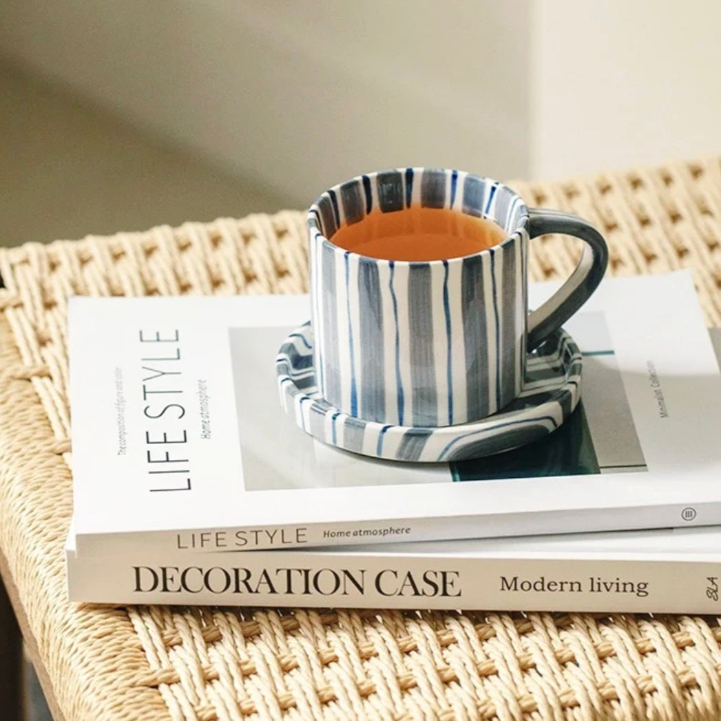 Durable ceramic cup and plate set with hand-painted cerulean blue stripes, ideal for coffee, tea and beverages, microwave and dishwasher safe.