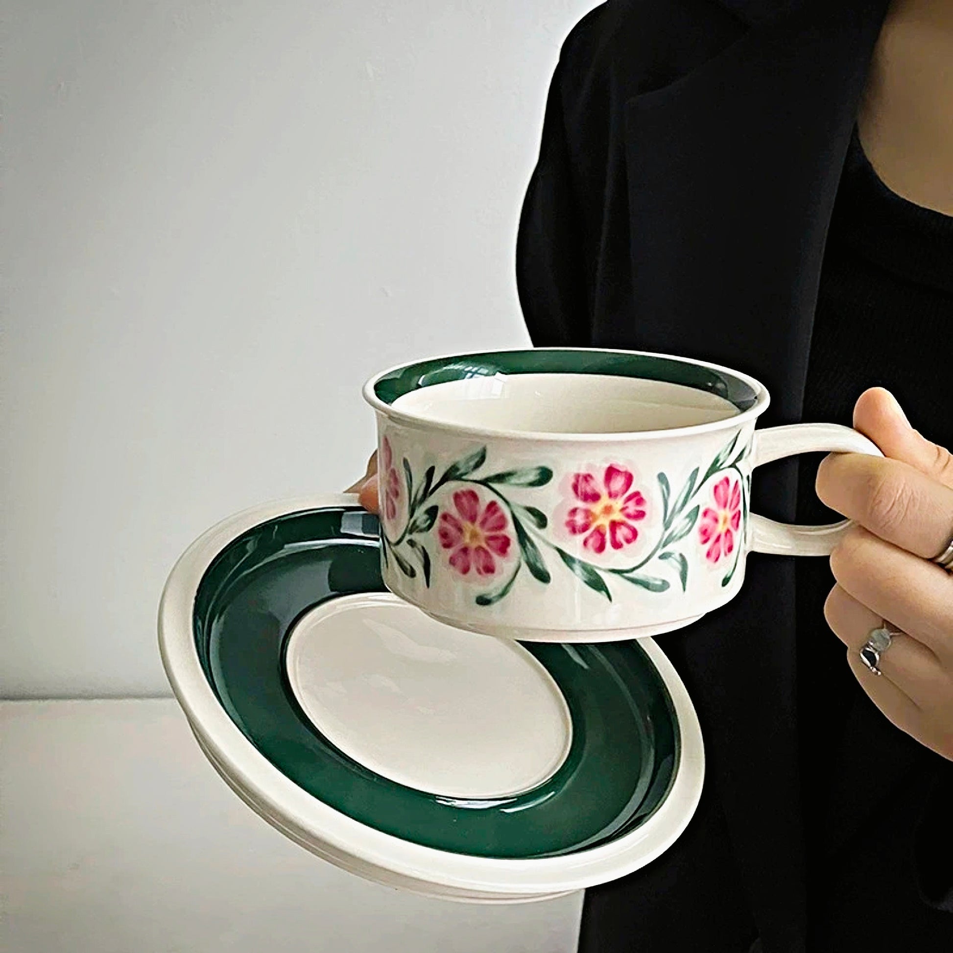 A ceramic cup made from eco-friendly materials, featuring colour floral designs and a comfortable handle.