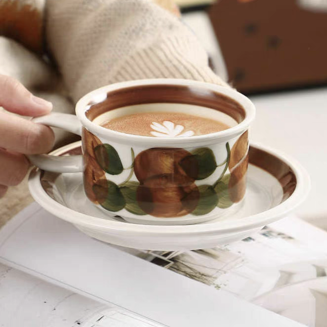 A coffee-filled ceramic cup with a hand-painted brushstroke design, heat-resistant and stylish for everyday use.