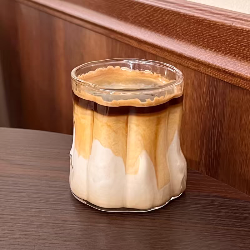 Dirty coffee in a 300ML Rippled Glass Cup, built from durable glass for hot and cold drinks, microwave and dishwasher safe.