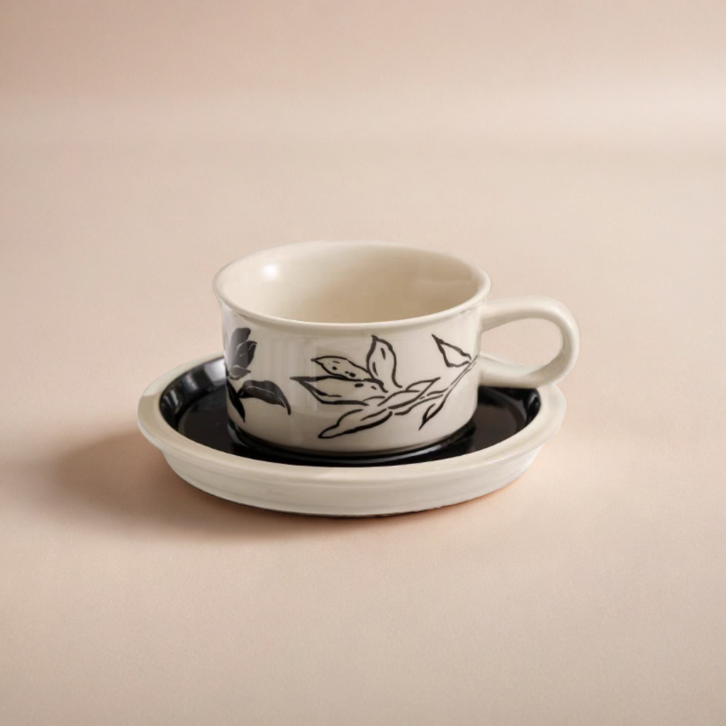 A ceramic coffee cup featuring nature-inspired patterns, blending Scandinavian style with rustic charm.