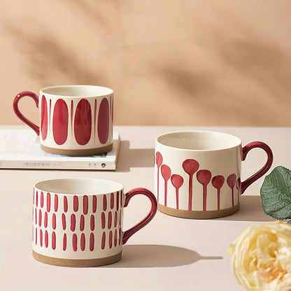 Showcase of four Nordic-inspired ceramic mugs with hand-painted red patterns, 450ml capacity, perfect for coffee and tea lovers.