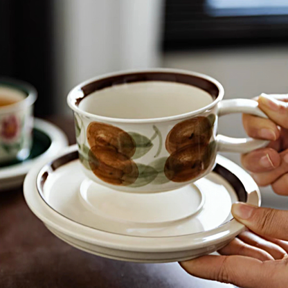 Ceramic cup and saucer made from eco-friendly materials, featuring artistic designs and a comfortable handle.