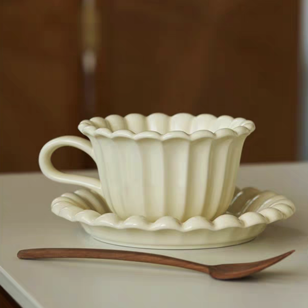 Scandinavian-style cream white coffee cup and plate set with floral design, perfect for minimalist home decor.