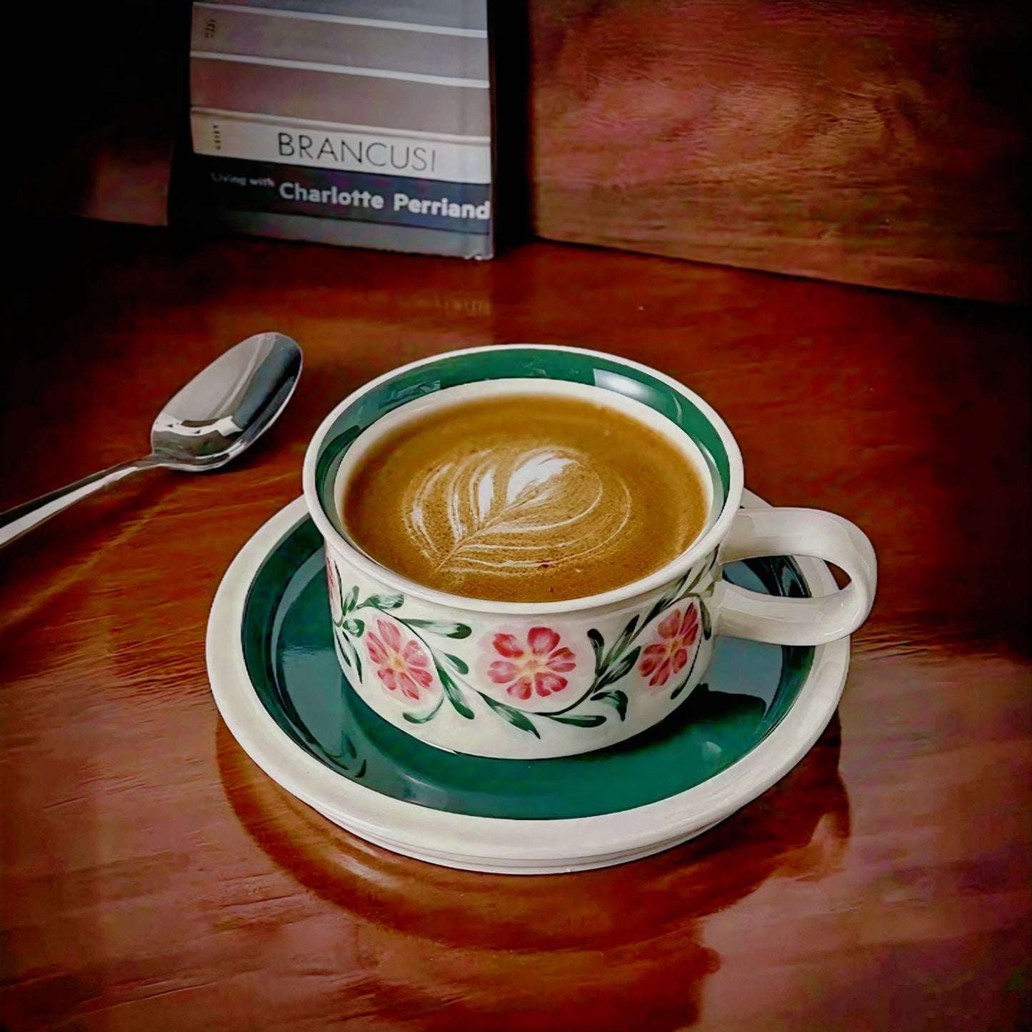 A ceramic cup with floral motifs in vibrant colors, ideal for coffee or tea, featuring eco-friendly materials and a smooth glaze finish.
