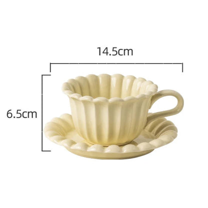 Stylish cream white floral ceramic cup and plate set, great for serving tea, coffee, and light beverages.