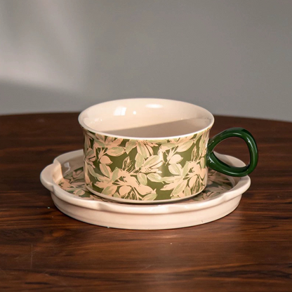 Handcrafted ceramic cup and saucer set with floral design—ideal gift for coffee and tea lovers.