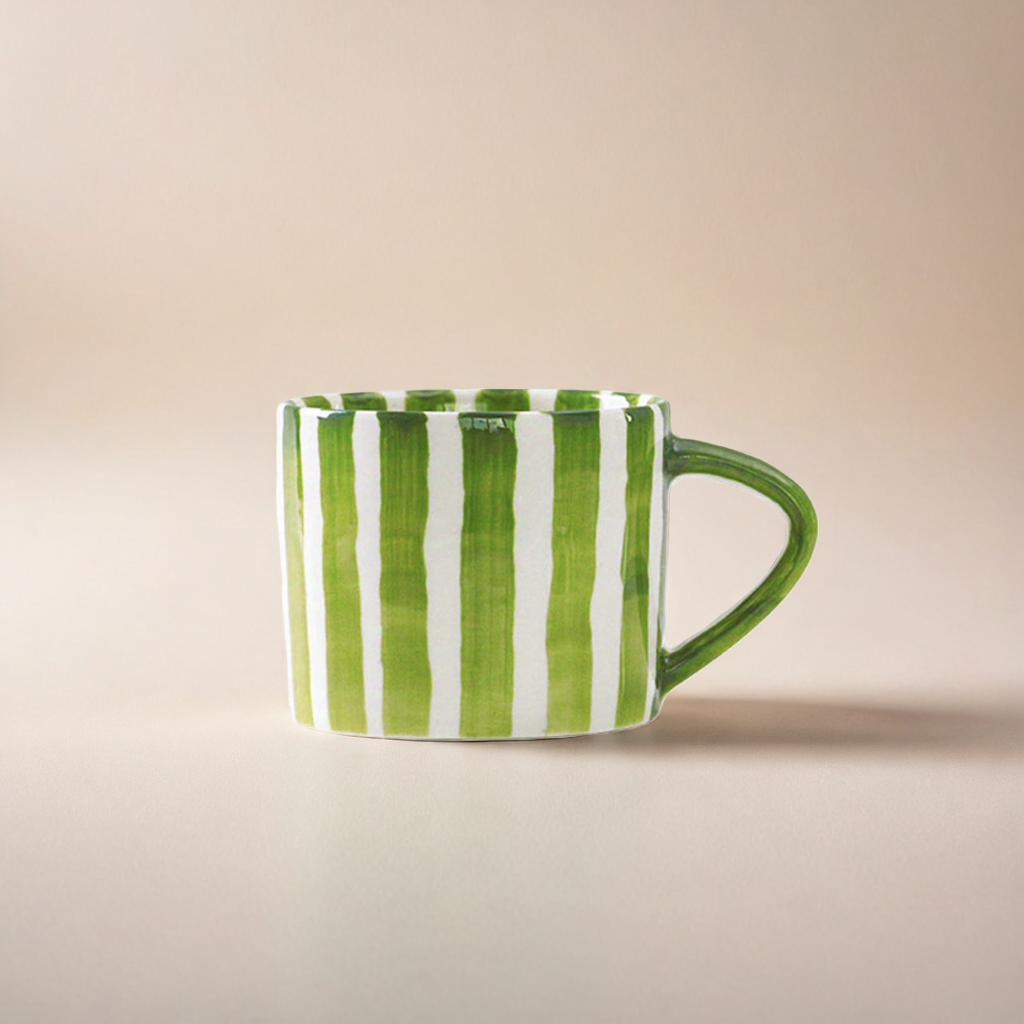 Modern ceramic cup with hand-painted green grass stripes, featuring a minimalist Scandinavian design and ergonomic handle, perfect for hot beverages.