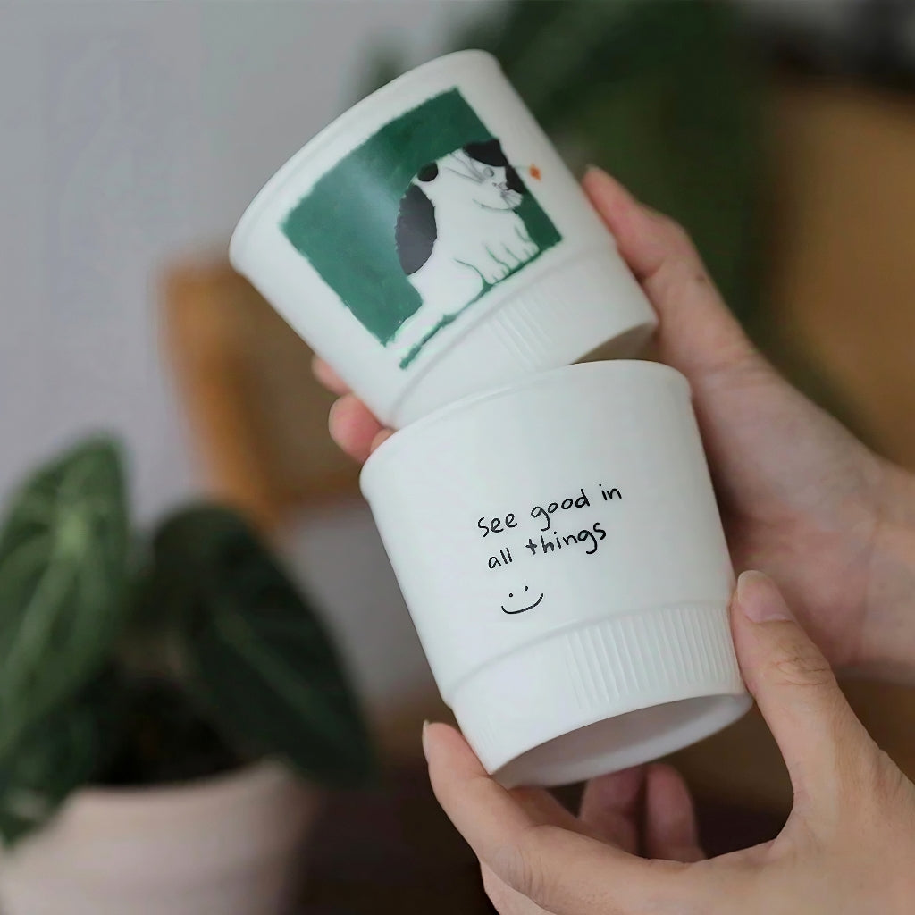 Adorable ceramic coffee mug with a sleepy kitten illustration. Made from durable underglaze ceramic, this 280ml latte mug is a sweet and whimsical cup for peaceful mornings and slow afternoons.