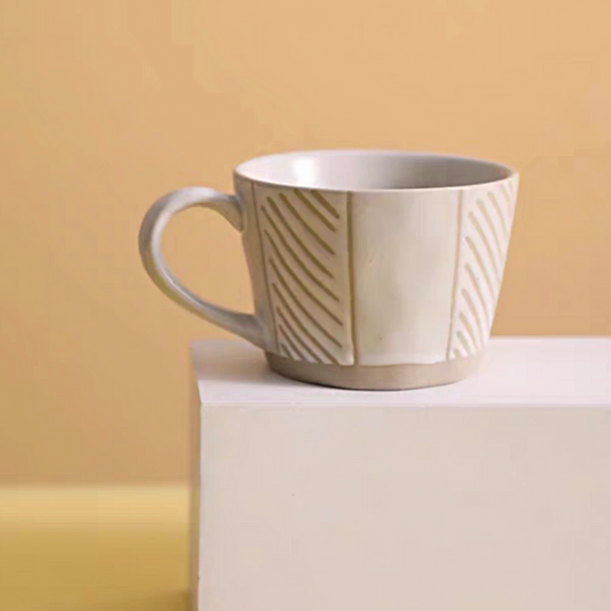 Hand-crafted textured ceramic cup with unique beige patterns, ideal for coffee, tea, and milk in stylish, minimalist settings.