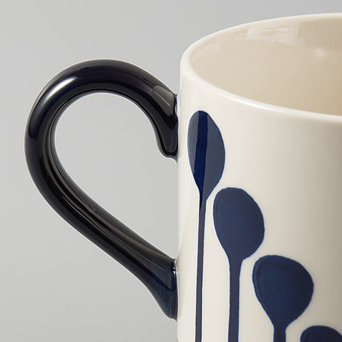 Detailed view of the handle of the artisan ceramic mug with a smooth glaze finish.