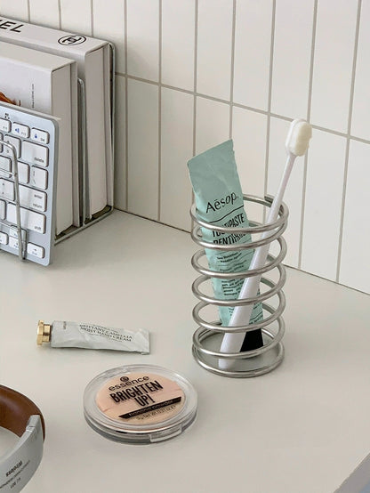 Modern brush holder made from stainless steel, suitable for organizing cosmetics and toiletries on your bathroom vanity or countertop.