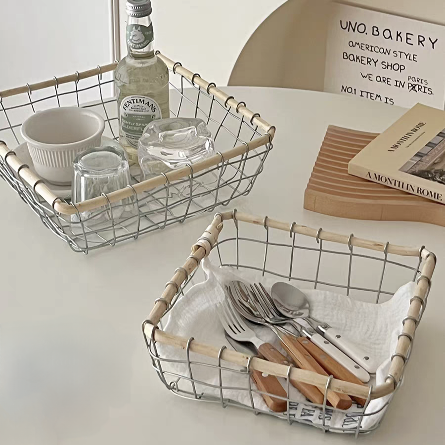 Square woven metal wire storage basket filled with tableware, showcasing its durable metal and natural rattan design in Scandinavian minimalism style. Two sizes available.