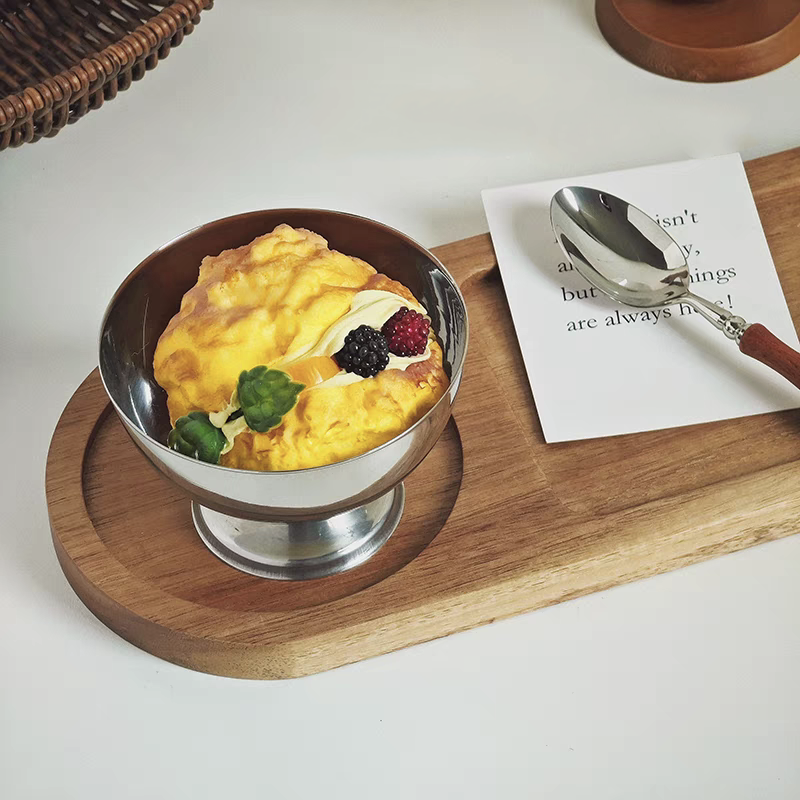 Elegant stainless steel dessert dish with a silver finish, beautifully displaying a layered dessert in a restaurant, highlighting its modern and minimalist design.