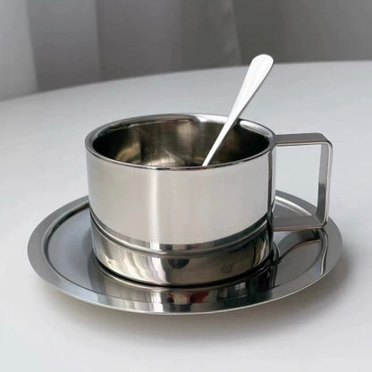 Sleek stainless steel coffee cup with matching tray and spoon, showcasing modern minimalism and industrial style, ideal for home and café serving.