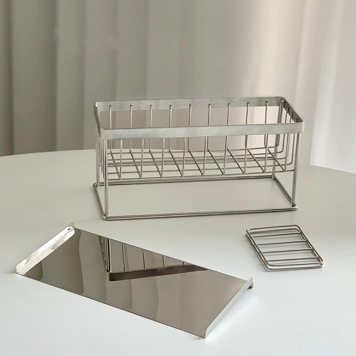 Functional metal storage rack with a removable drain tray, crafted for stylish and practical home organization.