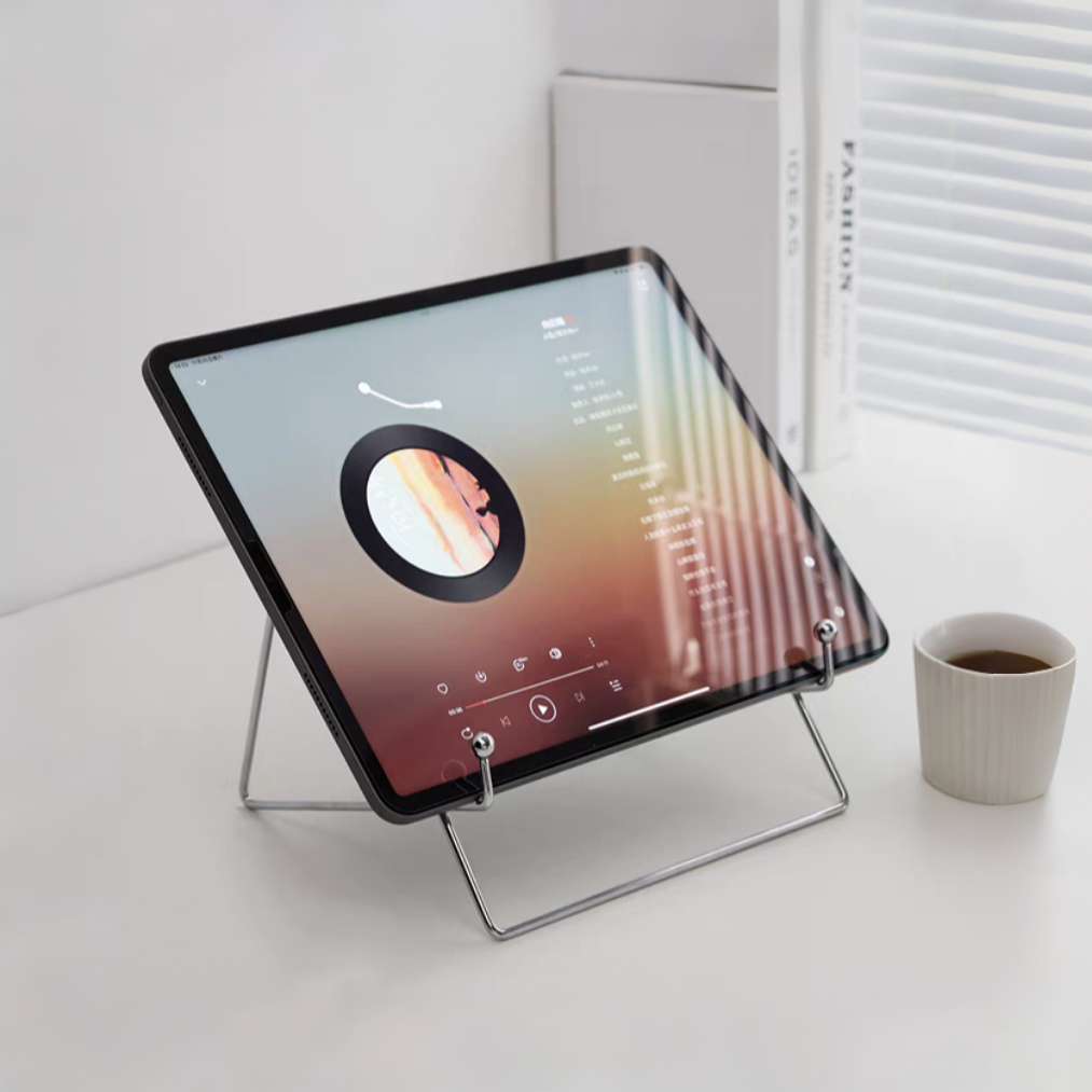 Minimalist stainless steel desktop stand displaying a tablet (ipad), emphasizing its modern design.