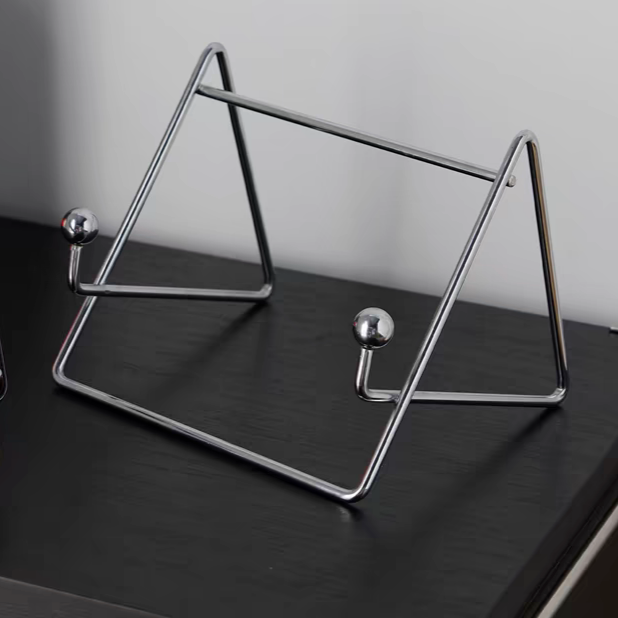 Contemporary stainless steel desktop organizer in silver, used to hold a tablet and a laptop.