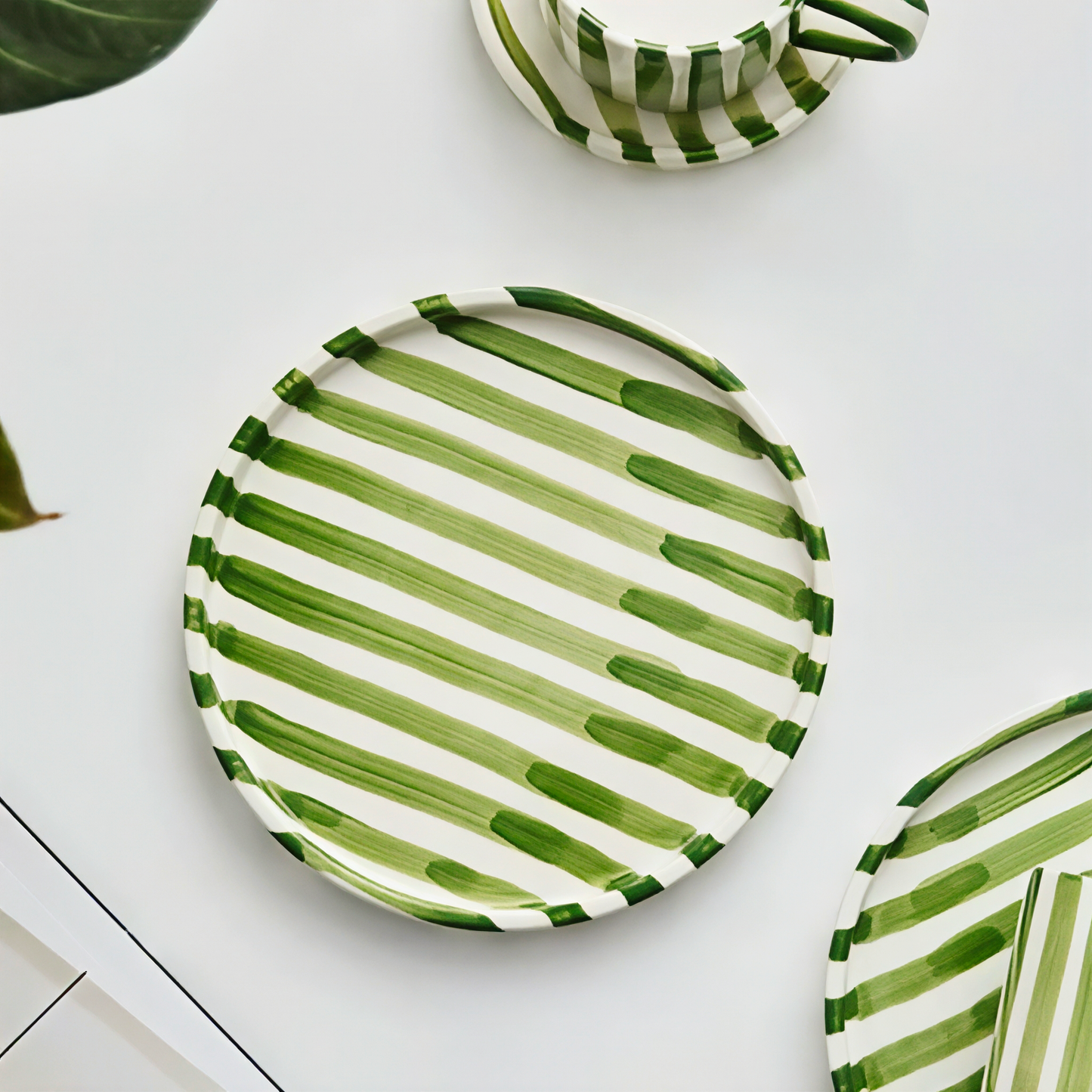 Multi-functional ceramic cup and plate set with vibrant green grass stripes, designed in minimalist Nordic style, perfect for serving drinks, cakes, and pastries.