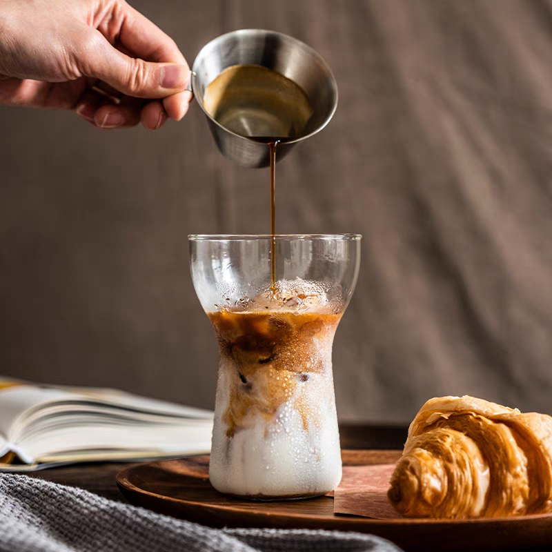 Durable, transparent glass cup featuring a latte, designed for coffee enthusiasts.