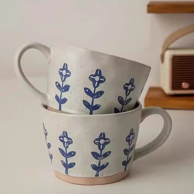 Handcrafted ceramic mug with a subtle blue floral design, perfect for coffee or tea in Japandi, cottage, Nordic or minimalist interiors.